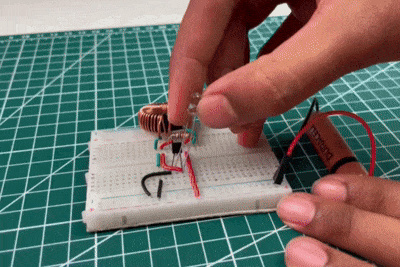 LED connected through Joule Thief Circuit showing bright illumination